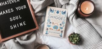A book about hygge, on a blanket