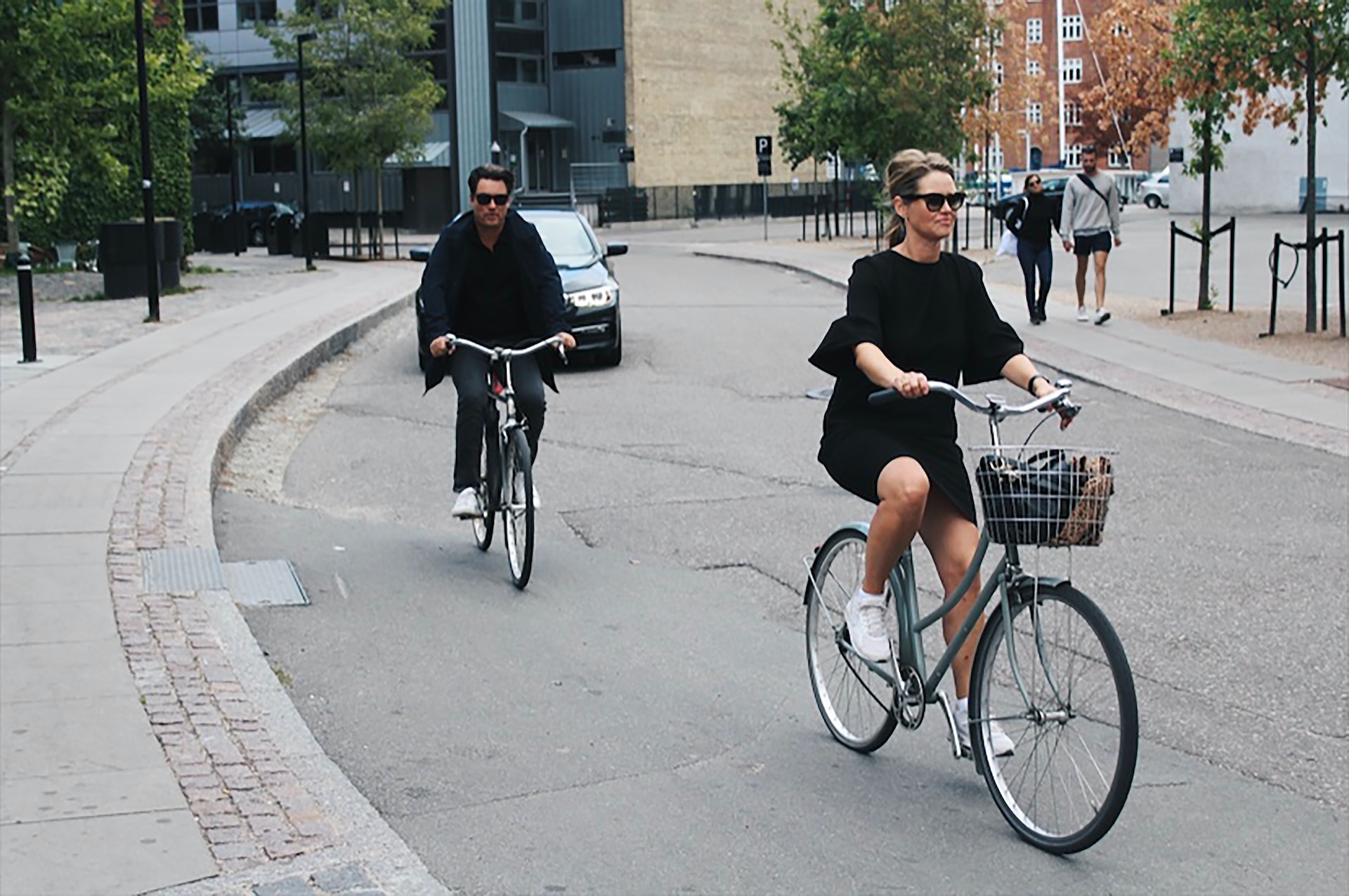 Two people riding bicycles in Copenhagen 