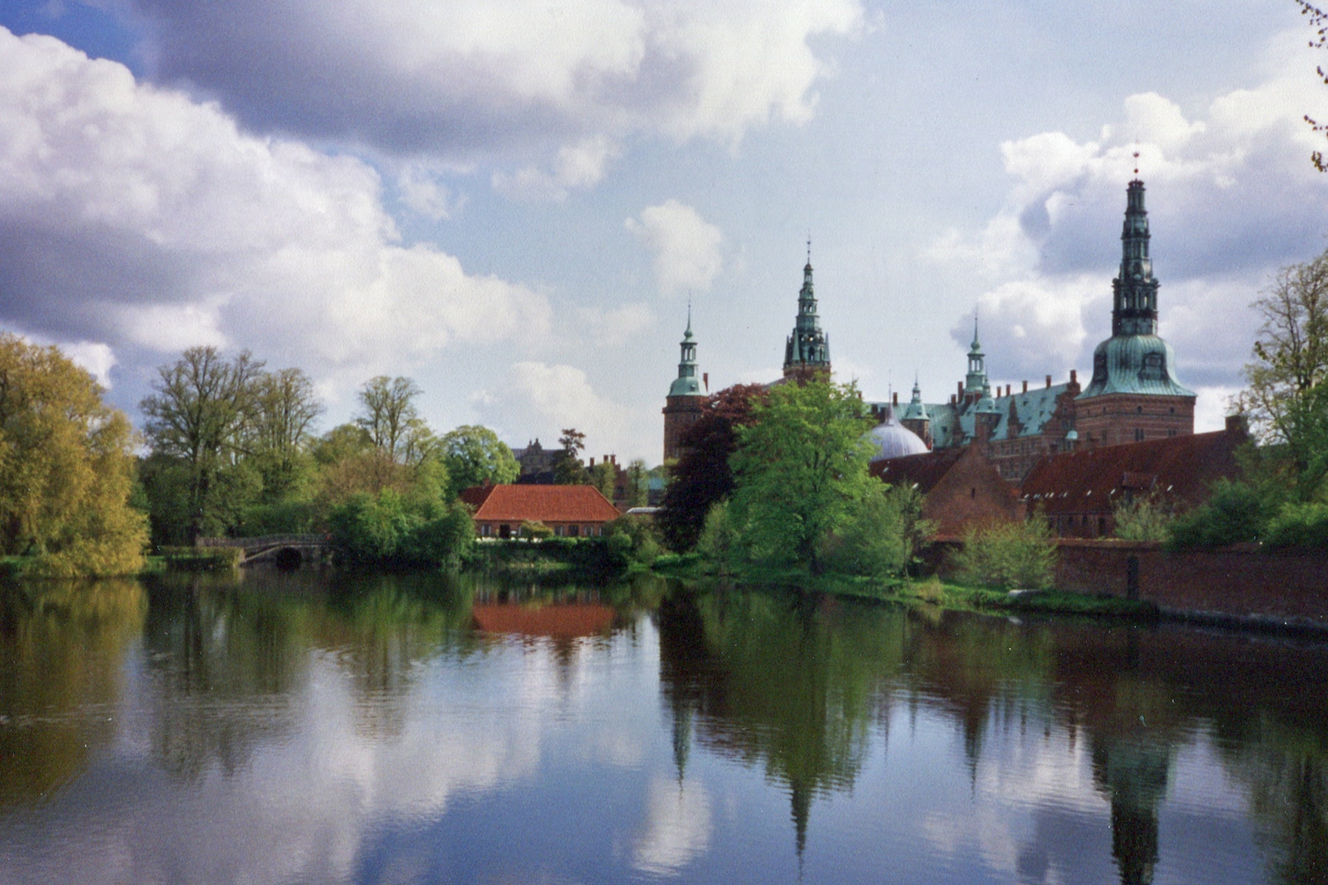Frederiksborg Castle on a cloudy day, surounded by Denmark's natural wonders